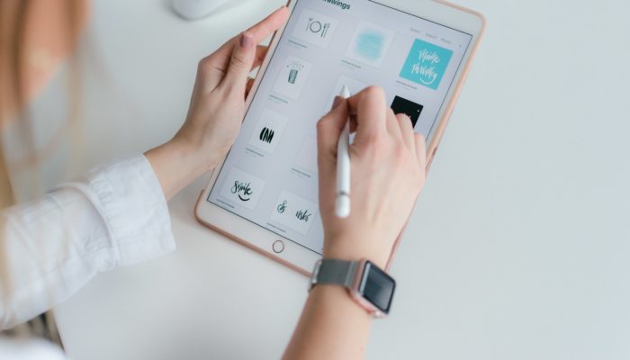 woman using rose gold iPad